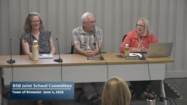 Three members of the school committee sitting at a table for the meeting