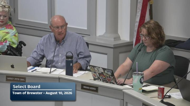 Two members of the committee sitting behind the dias